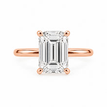 Load image into Gallery viewer, An emerald-cut diamond engagement ring with a rose gold band and prongs, centered on a clean white background.