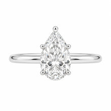 Load image into Gallery viewer, A pear-cut diamond engagement ring in a four-prong setting on a polished silver band, centered against a plain white background.