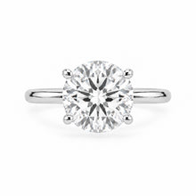 Load image into Gallery viewer, A classic solitaire engagement ring featuring a round brilliant-cut diamond set in a polished silver-colored metal band, shown against a plain white background.