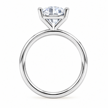 Load image into Gallery viewer, A silver-toned solitaire engagement ring featuring a round brilliant-cut clear gemstone in a four-prong setting, shown against a plain white background.