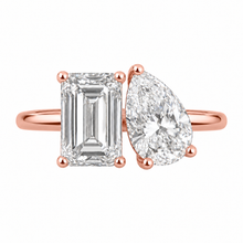 Load image into Gallery viewer, A rose gold ring featuring a rectangular emerald-cut diamond on one side and a pear-cut diamond on the other, set against a plain white background.