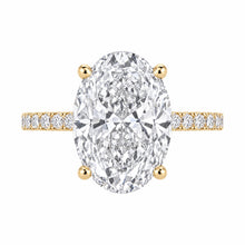 Load image into Gallery viewer, An oval diamond engagement ring featuring a large central marquise-cut diamond in a four-prong setting with yellow gold accents on the shoulders and band, set against a plain white background.
