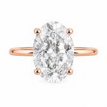 Load image into Gallery viewer, An oval-cut diamond engagement ring in a rose gold four-prong setting on a plain white background.
