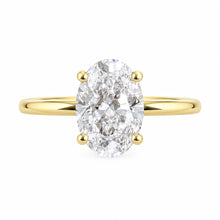 Load image into Gallery viewer, An oval-cut diamond engagement ring with a yellow gold band and prongs, centered on a plain white background.
