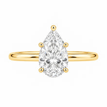 Load image into Gallery viewer, A pear-cut diamond engagement ring in a yellow gold band, set against a plain white background.
