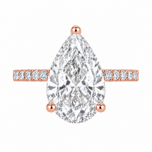 Load image into Gallery viewer, A pear-cut diamond engagement ring in rose gold, featuring a large central diamond with a diamond-accented band, set against a plain white background.
