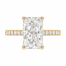 Load image into Gallery viewer, A yellow gold engagement ring featuring a large rectangular radiant-cut diamond center stone and a pavé-set diamond band, shown on a plain white background.
