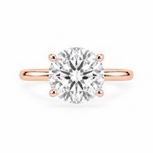 Load image into Gallery viewer, A round-cut diamond solitaire engagement ring in a rose gold band with a four-prong setting, shown against a plain white background.

