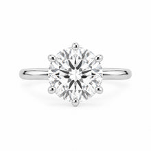 Load image into Gallery viewer, A silver solitaire engagement ring featuring a round brilliant-cut clear gemstone in a six-prong setting, shown against a plain white background.
